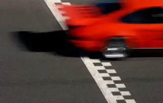 Race Car crossing Finish Line, rear end, blurred