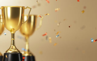 Golden trophy cup on gold background. copy space for text. 3d rendering.