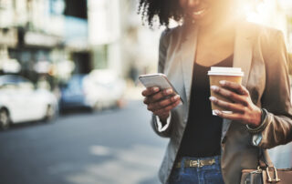 Closeup shot of a businesswoman using a cellphone in the city